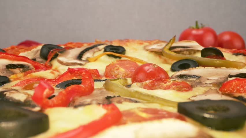 Healthy vegetarian pizza loaded with colorful bell peppers olives and onions.