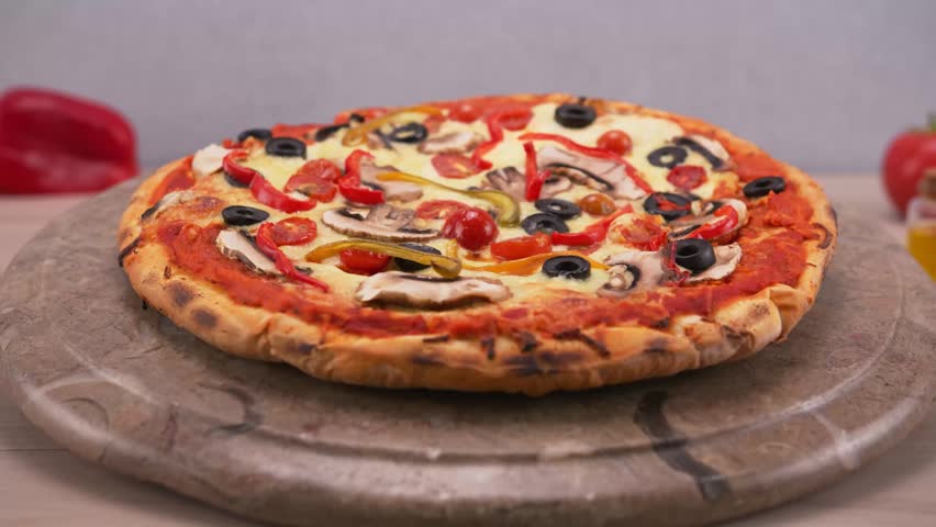 Healthy vegetarian pizza loaded with colorful bell peppers olives and onions.