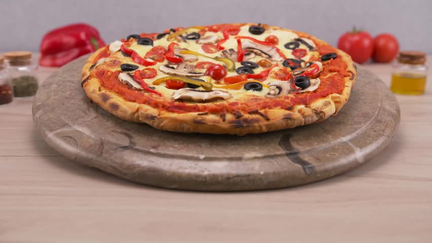 Healthy vegetarian pizza loaded with colorful bell peppers olives and onions.