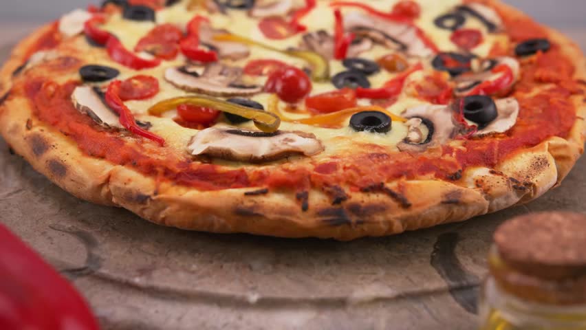 Healthy vegetarian pizza loaded with colorful bell peppers olives and onions.