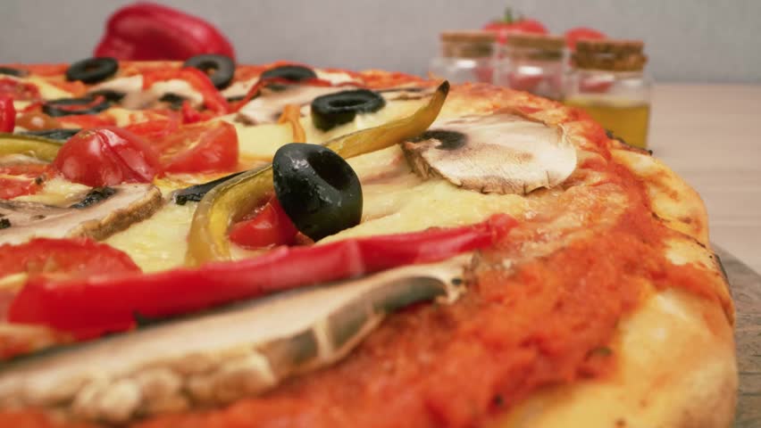 Healthy vegetarian pizza loaded with colorful bell peppers olives and onions.