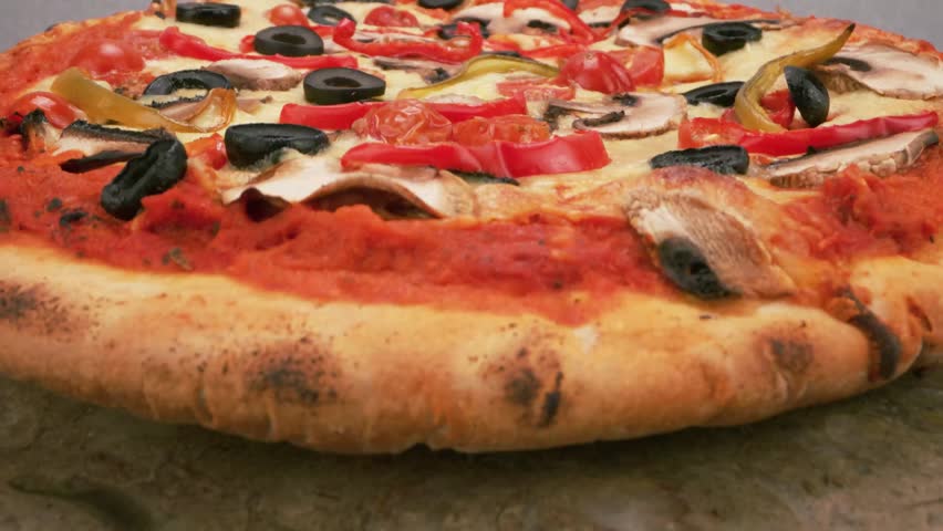 Healthy vegetarian pizza loaded with colorful bell peppers olives and onions.