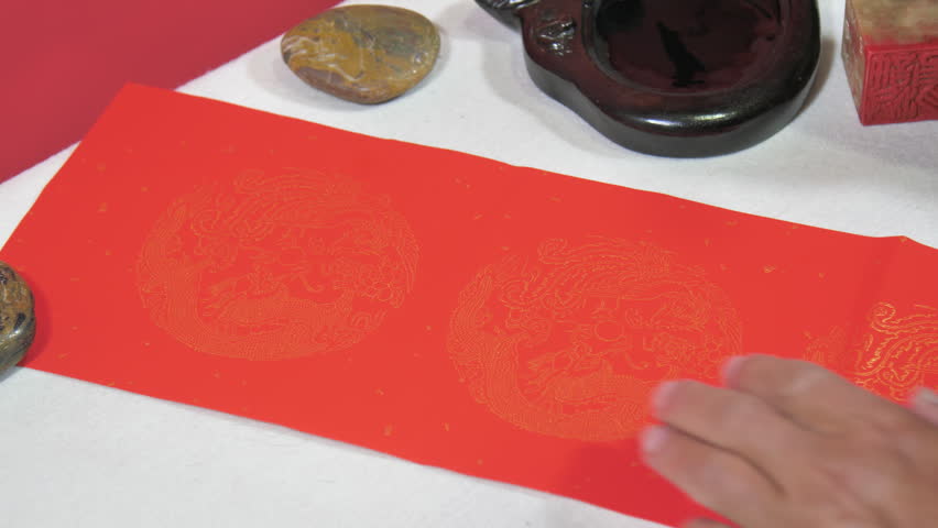 Writing Spring Festival couplets and giving red envelopes。“福”means blessing.”吉祥如意“means Good luck and good luck.