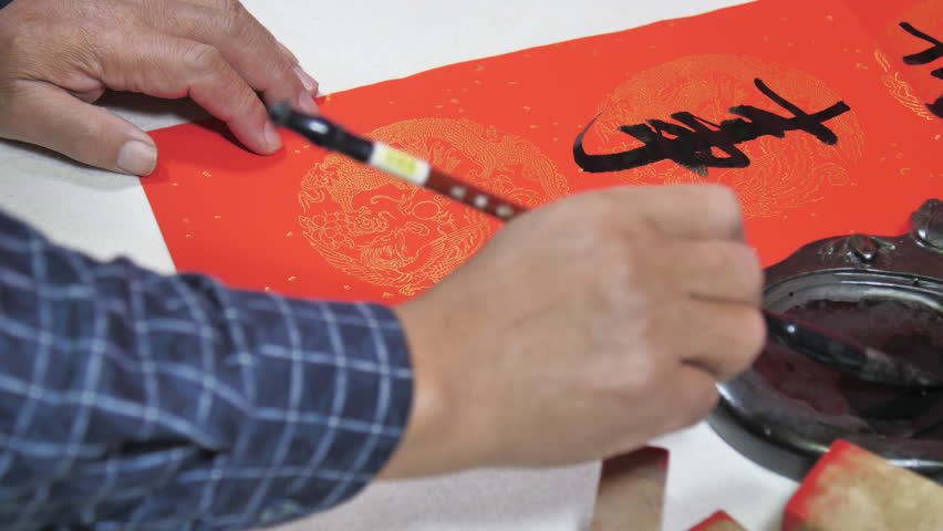 Writing Spring Festival couplets and giving red envelopes。“福”means blessing.”吉祥如意“means Good luck and good luck.