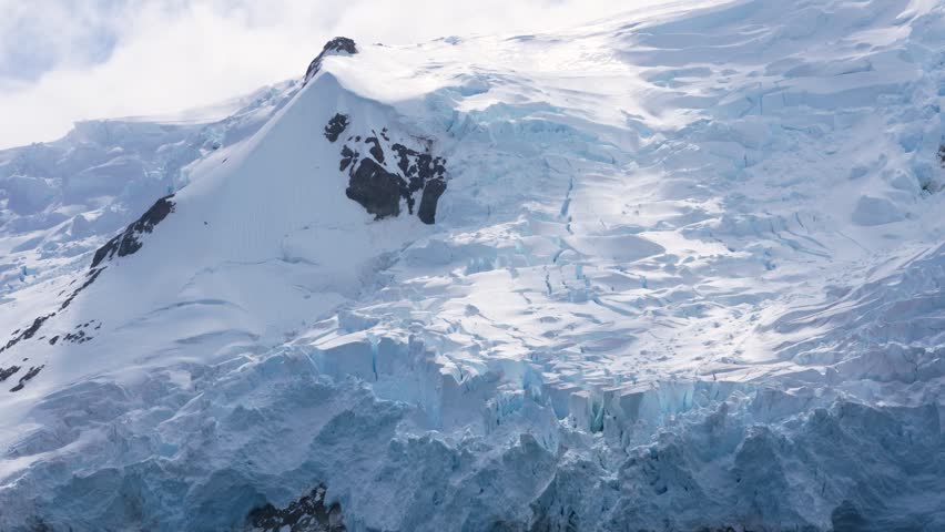 Antarctica Snow and Glacier Close Up View From Cruise Ship. Stunning Landscape Beautiful Lighting Day. Rugged Mountain Range Island