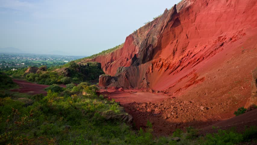 Open pit mine on tecajete hill with the popocatepetl volcano visible in the background at dawn