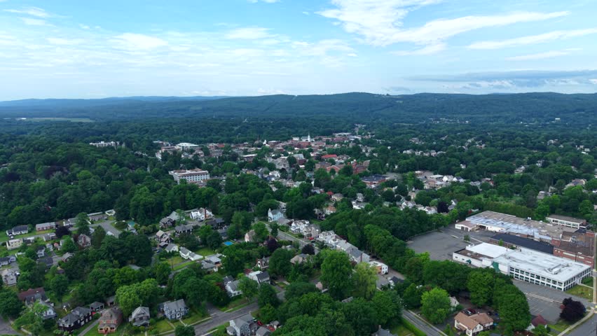 Townscape Of Greenfield Surrounded By Distant Green Hills In Massachusetts, USA. aerial ascending shot