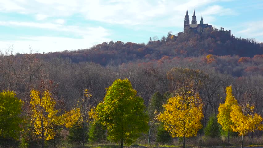 Aerial view of Holy Hill Basilica on a colorful autumn hilltop.