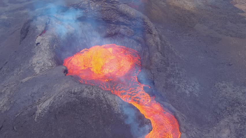 Fiery lava stream from volcano, smoke billowing.