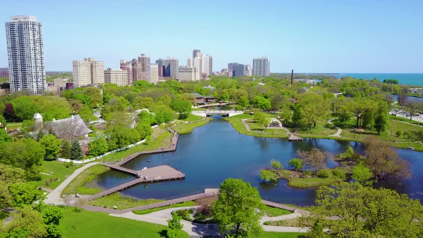 Aerial park view, city skyline, green trees, lake Michigan.