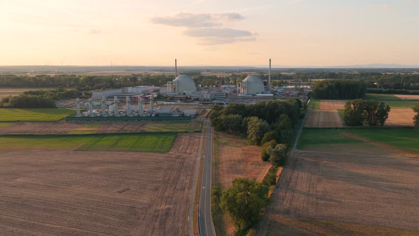 Aerial view of the Biblis Nuclear Power Plant with its iconic cooling towers, surrounded by agricultural fields and rural landscape in Biblis, Hessen, Germany.