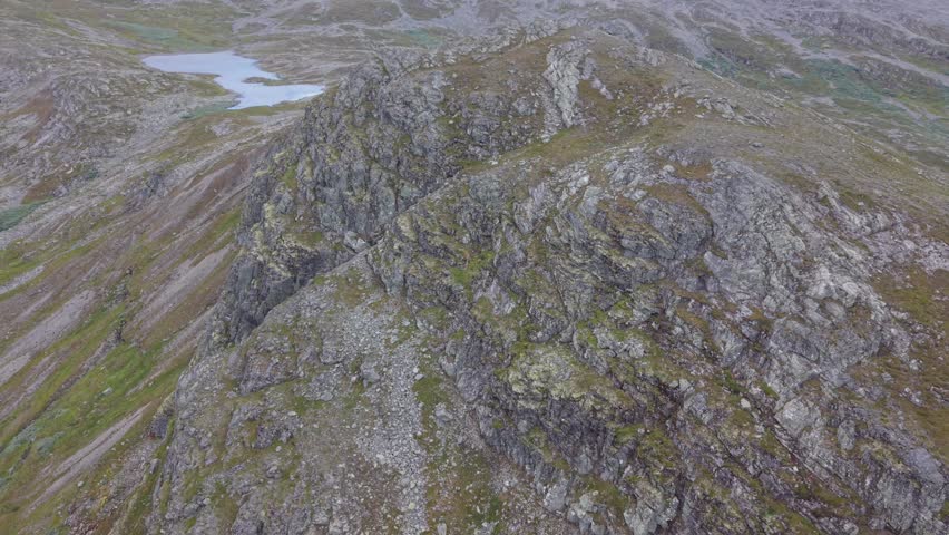 Aerial view of the rugged rocky slopes and mossy terrain of Hydalshjallen mountain in Hemsedal, Buskerud, Norway.