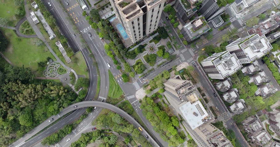 Top down aerial view of Taipei, the vibrant capital city of Taiwan, showing streets and high-rise buildings in the Xinyi District on a sunny day.