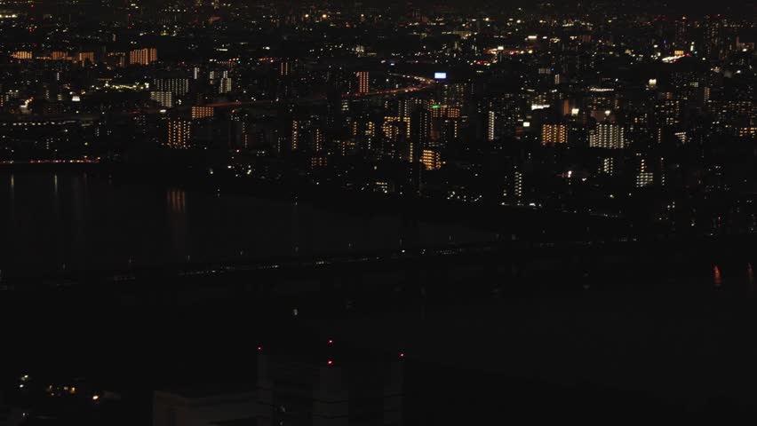 Osaka Cityscape At Night View From The Umeda Sky Building In Japan. POV Wide Shot