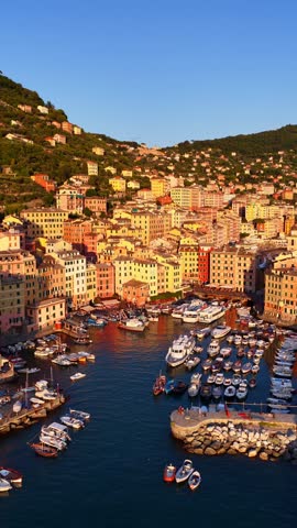 vertical drone video of a luxury resort of Camogli on the Mediterranean coast of Italy, Italian Riviera, sunset in Liguria, vacation in Italy, scenic fishing village in Italy