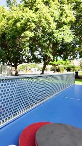 Table tennis paddles and ball on ping pong table