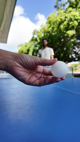 Playing table tennis with paddle and ball
