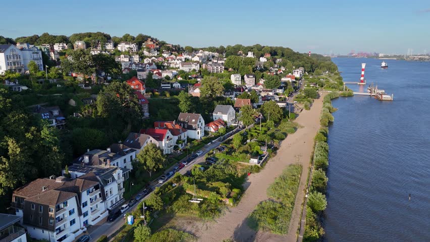 Aerial view of the historic Treppenviertel Blankenese neighborhood with hillside houses, lush greenery, and the Elbe river in Hamburg, Hamburg, Germany.