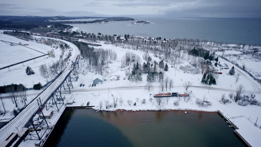 Scenic aerial footage of Marquette, Michigan blanketed in snow.