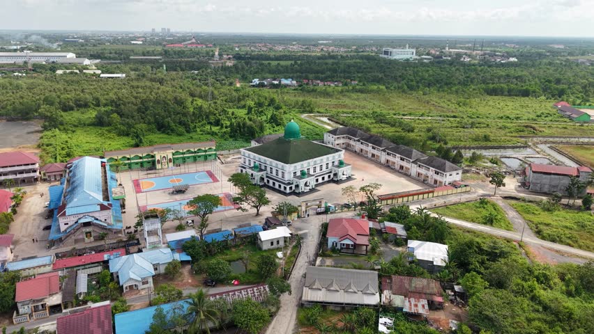 Aerial view of an Islamic boarding school with a large mosque inside