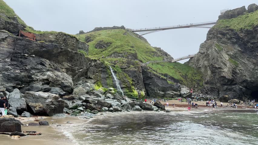 Coastal cliffs with a scenic footbridge overlooking the rocky shoreline. Beautiful natural landscape with ocean waves and dramatic coastal scenery.