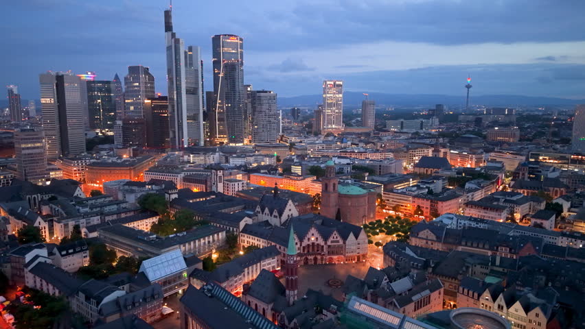 Erial Urban skyline at dusk with buildings and river in city of Frankfurt, Germany