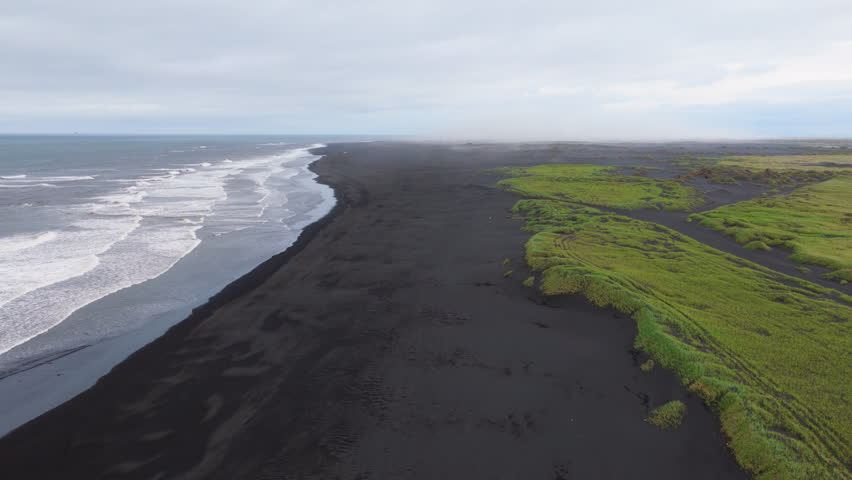Aerial view of ocean crashing on the beach. black sand. Iceland