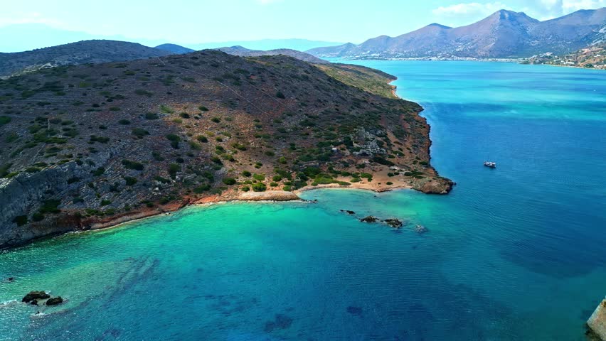 Aerial view of the rocky coastline and turquoise bay of Crete, Greece.