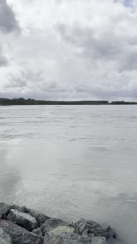 Scenic views of a river flowing through Talkeetna, Alaska, surrounded by forests, mountains, and the breathtaking natural beauty of the Alaskan wilderness during summer.