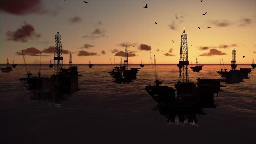 Oil rigs in ocean, time lapse sunrise, tilt