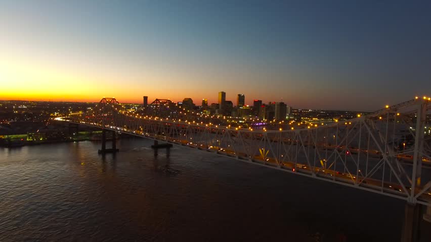 Aerial view of a bridge over a river at night in new orleans.
