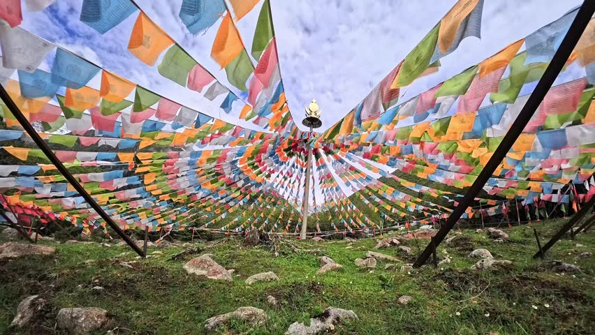 Waving colorful tibetan prayer flags at Dagu Glacier National Park on a summer morning