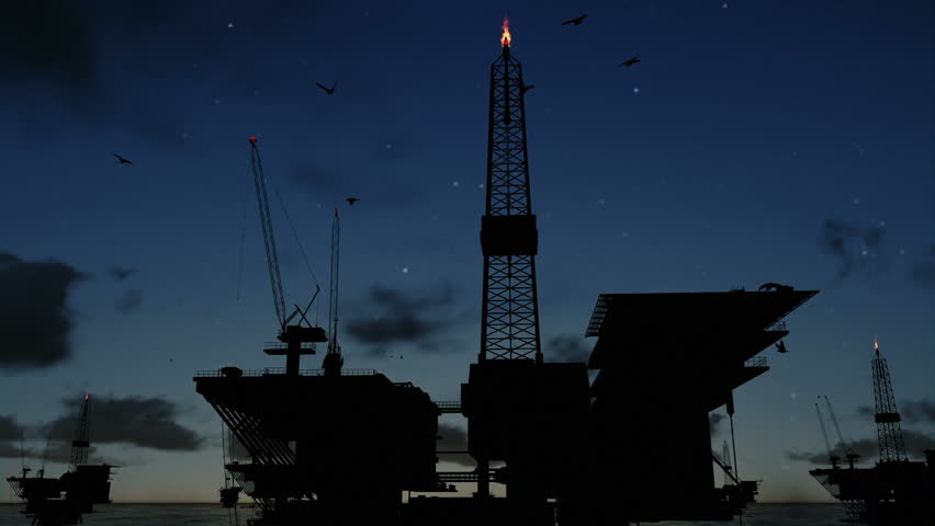 Oil rigs in ocean at night, time lapse clouds