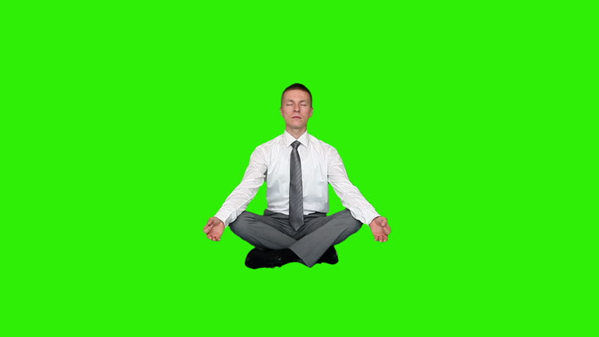Young relaxed businessman meditating, Green Screen