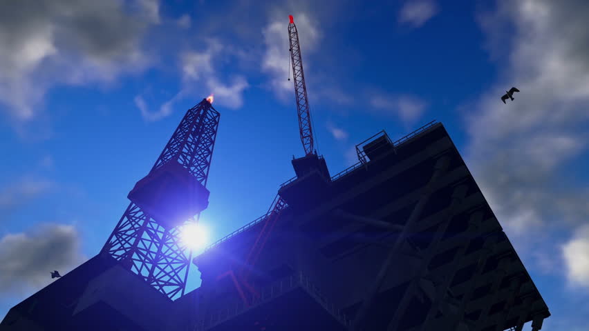 Oil Rig against blue sky, time lapse night to day