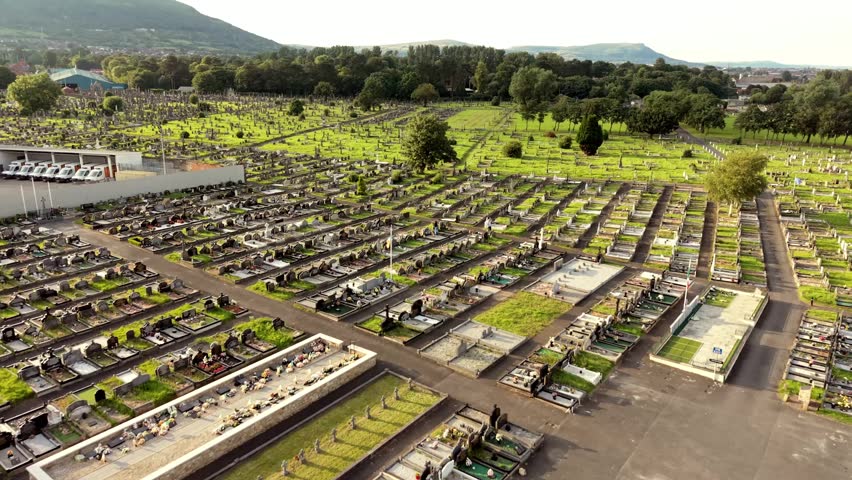 Front-on 4K 60FPS aerial video of Milltown Cemetary and the Irish Republican Plot on the Falls Road in Belfast, Northern Ireland, UK. Produced with broadcast ready Rec709 color.