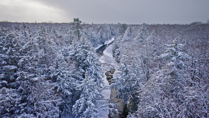 Beautiful winter scenery featuring a river winding through snow-covered terrain.