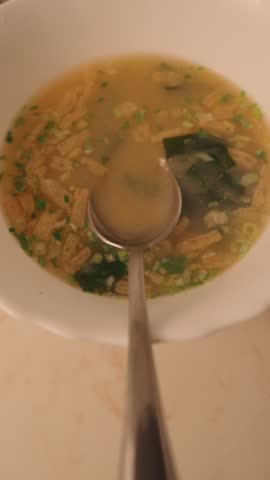Serving hot seafood soup with spoon	