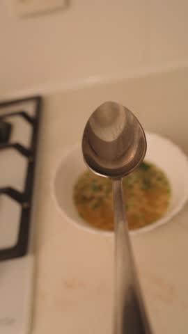 Serving hot seafood soup with spoon	