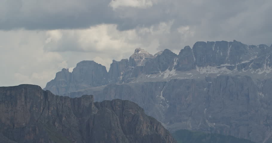Majestic view of the sella group massif in the dolomites, italy, with clouds moving over peaks