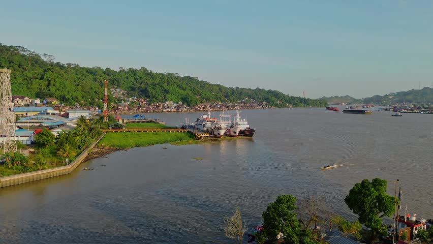 Aerial view of ships docked at the riverbank of the Mahakam River in Samarinda, East Kalimantan, Indonesia.
