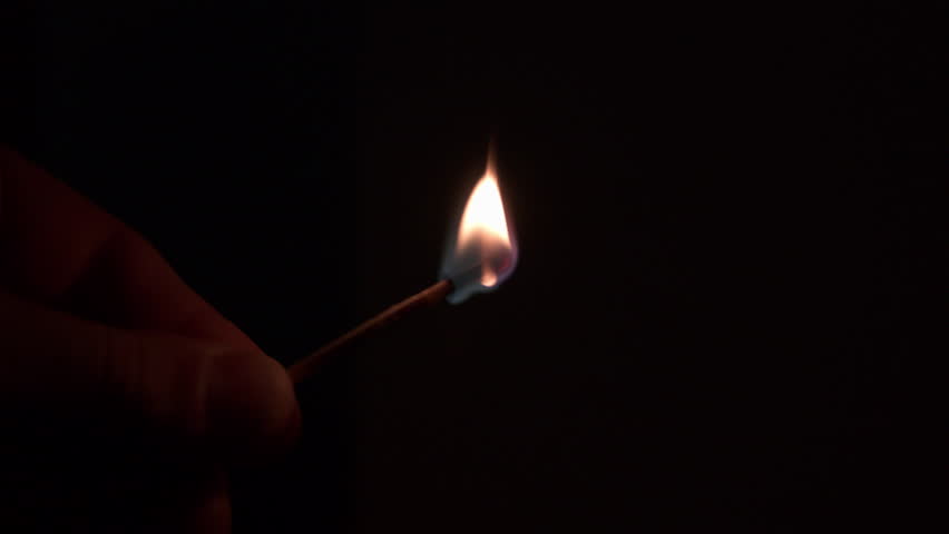 Lit match stick burns down and fades to a small glowing ember against a dark background.