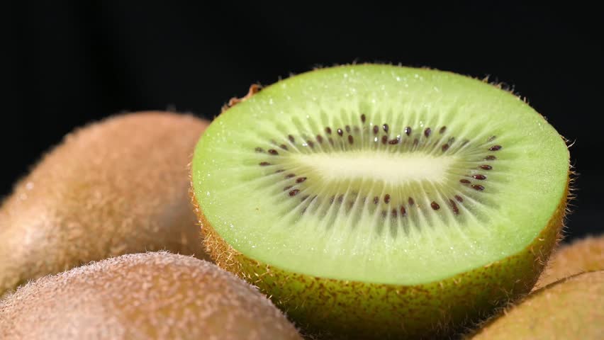 Fresh Kiwi Slices on Plate with Black Background	
