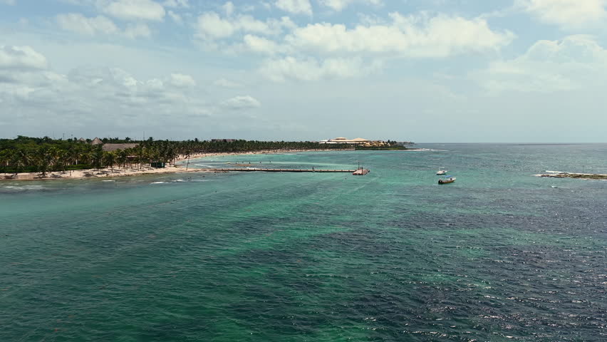 Aerial view of Caribbean sea ,sandy beach, pier with docked boats and palm trees in Playa del Carmen, Cancun, Mexico
