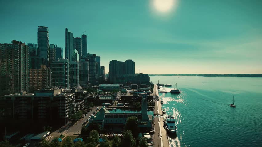 Aerial view toward downtown Toronto with the CN Tower and high-rises above Lake Ontario