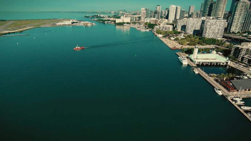 Cinematic aerial view of downtown Toronto skyline with the CN Tower above the waterfront on a clear summer day
