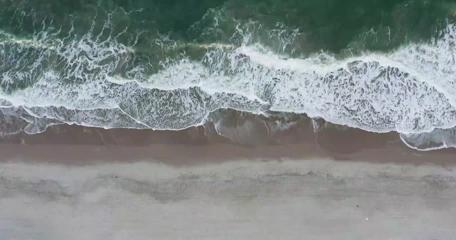 A stunning top-down time-lapse capturing ocean waves in constant motion as they create mesmerizing patterns across the water surface. Filmed from above, the dynamic movement of waves and sea foam forms beautiful abstract textures, making this footage ideal for nature, marine, travel, relaxation, environmental, and background projects.