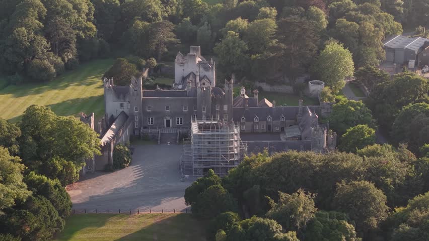Golden sunset aerial close up over historic Howth Castle and surrounding parkland, County Dublin