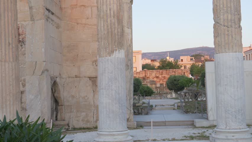 Imposing ancient columns stand against the clear blue sky at Hadrian