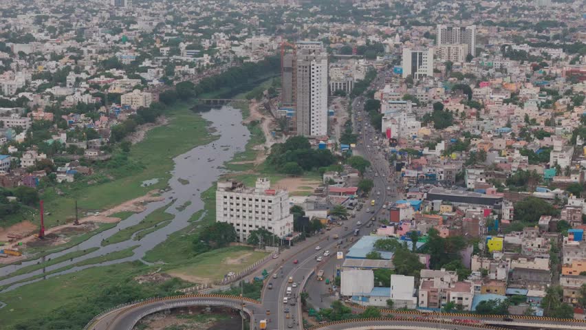 River winds past a busy highway flyover as drone drifts across Chennai